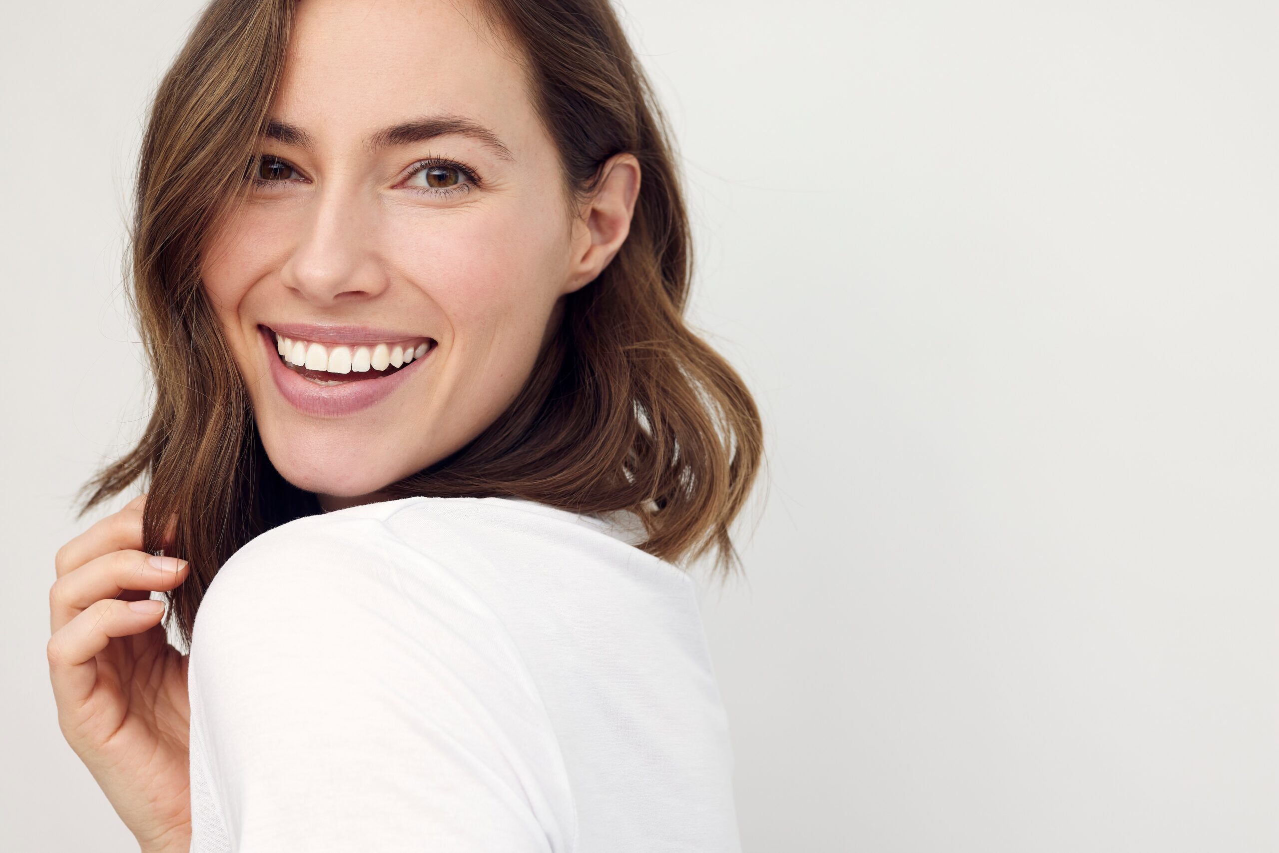 Closeup,Portrait,Of,Young,Happy,Woman,Looking,In,Camera