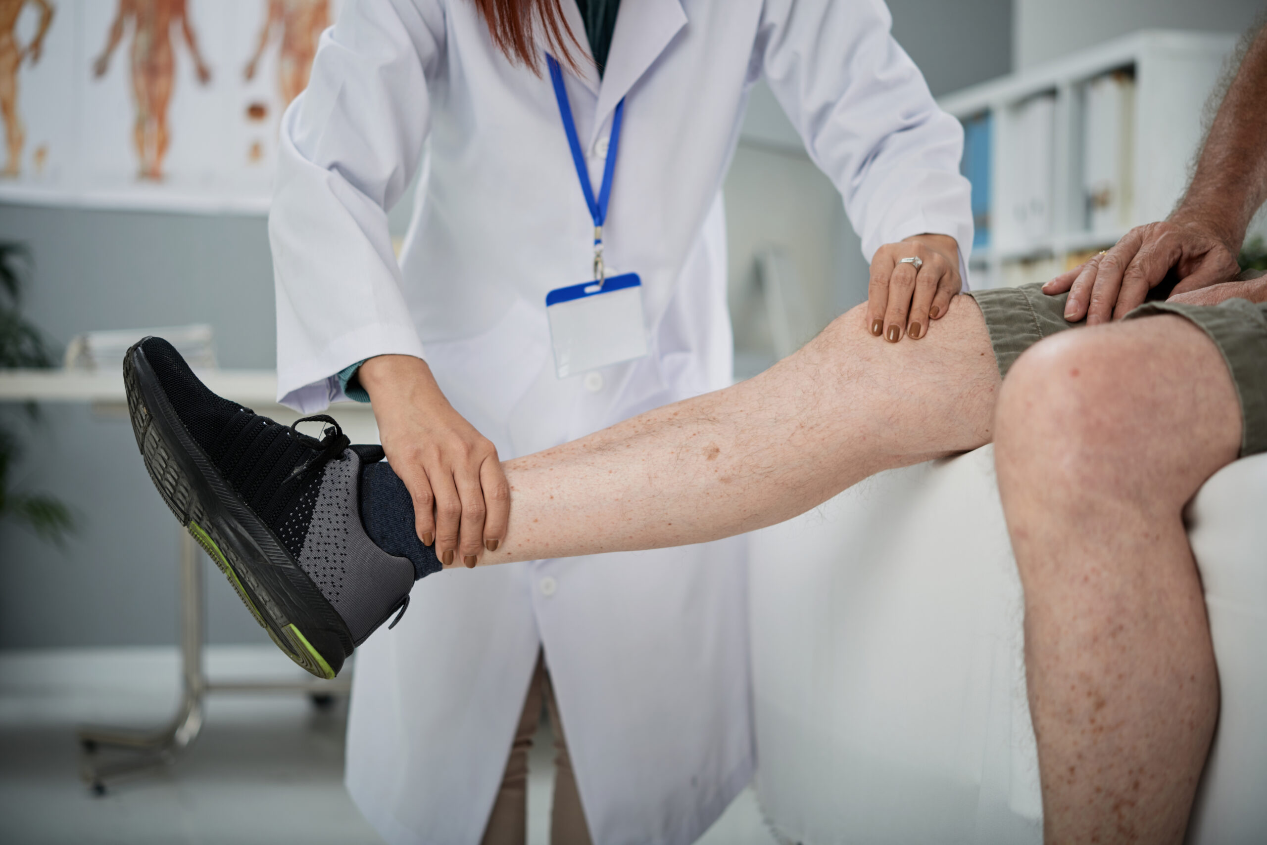 Physiotherapist palpating leg