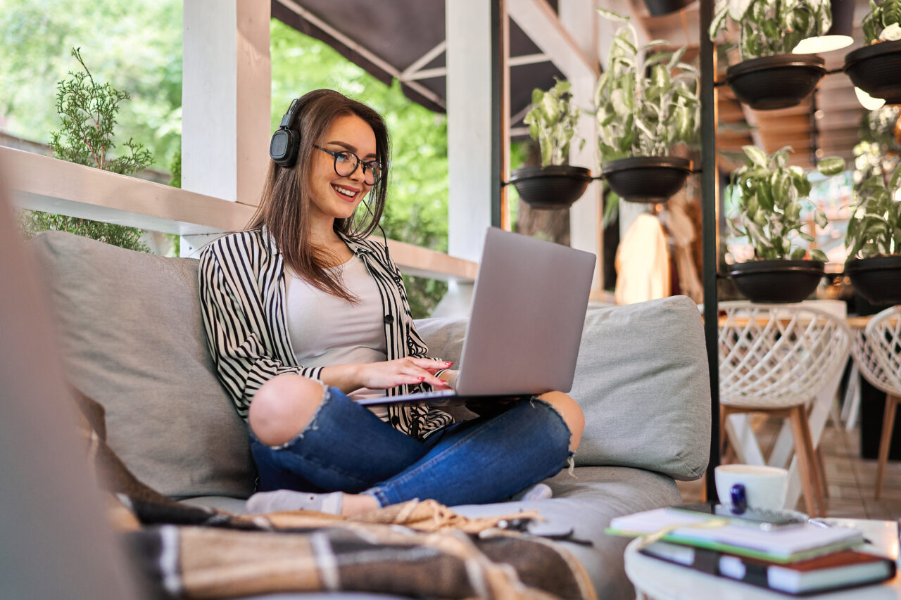 Beautiful student girl learning at home with laptop