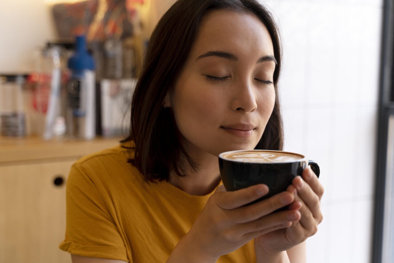 close-up-woman-holding-coffee-cup