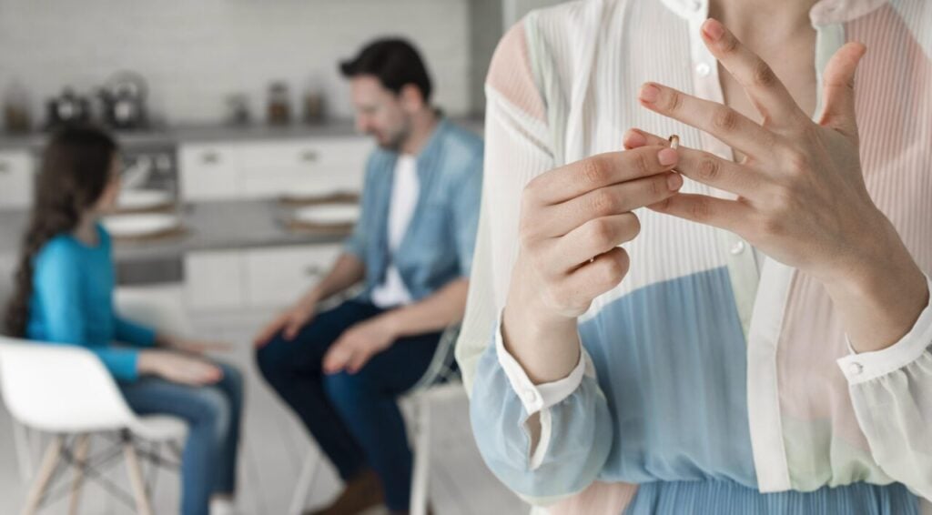 close-up-woman-taking-wedding-ring-off