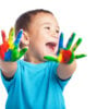 cheerful child with painted hands on white background