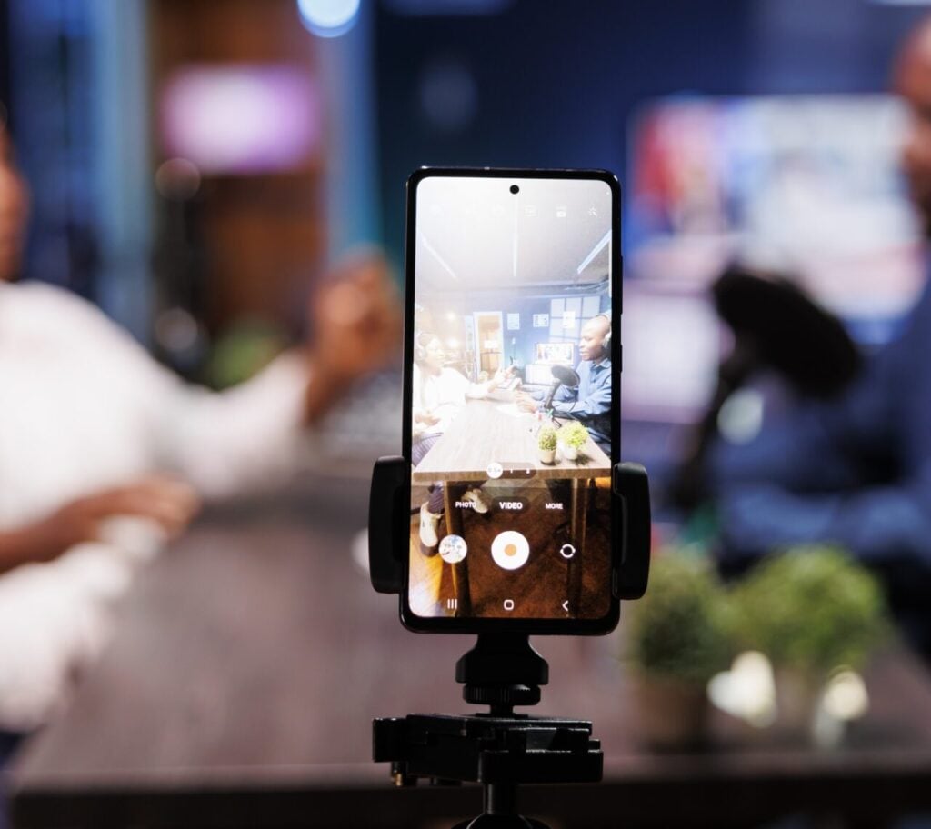 Smartphone on tripod records influencers